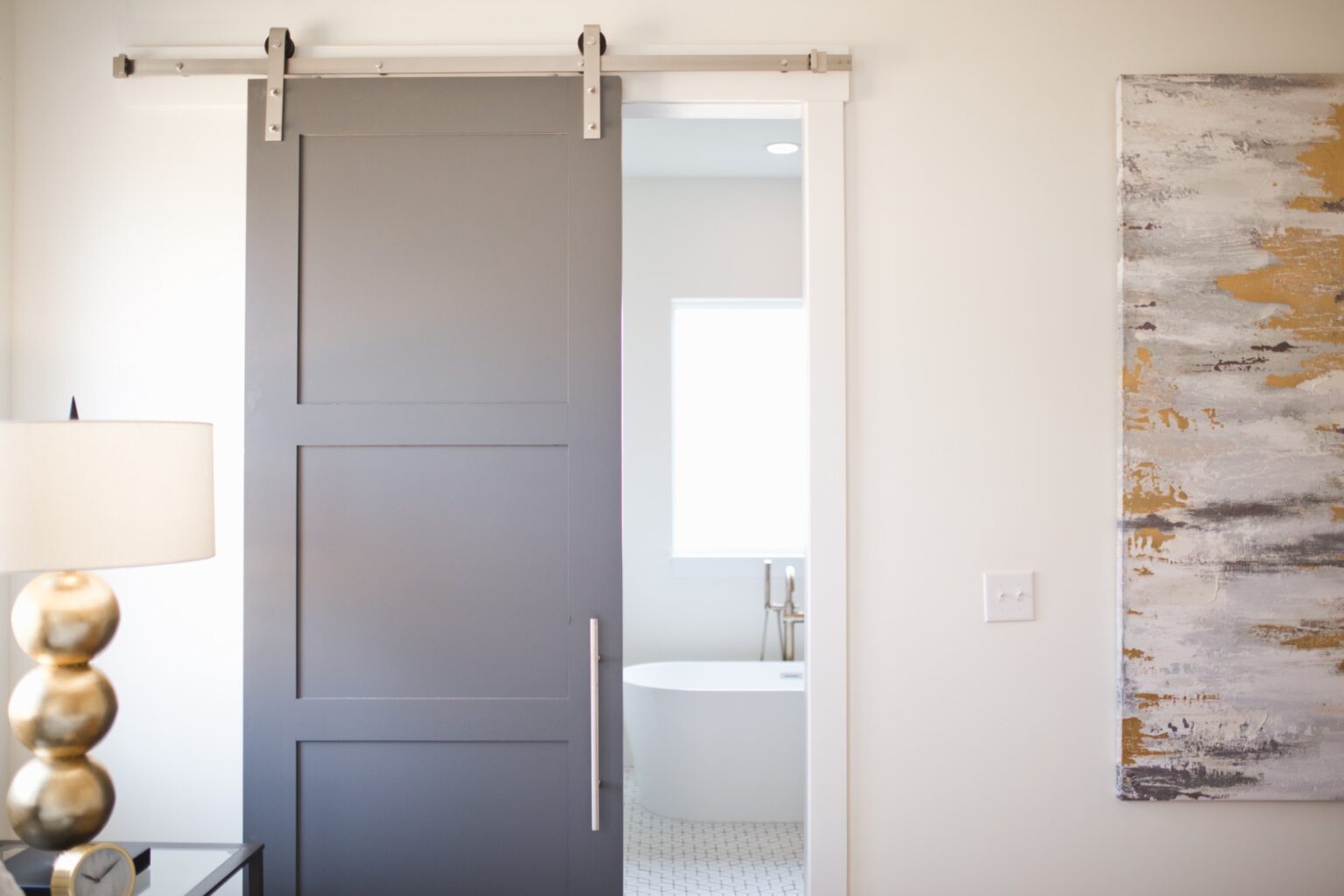 A bathroom with a sliding door and tub